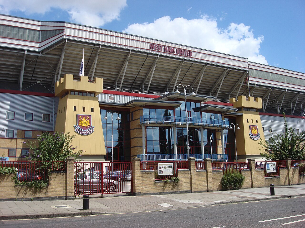 The front of the main stand at the Boleyn Ground, Upton Park, with two castle-style towers carrying the West Ham United crest